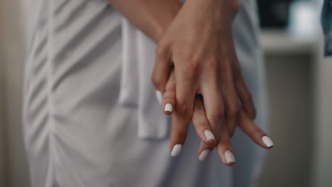 Woman-with-white-manicure-does-gymnastics-for-fingers