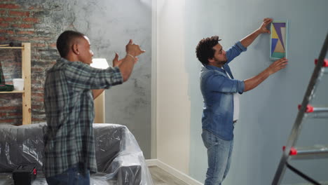 Black-guy-advises-brother-to-turn-abstract-picture-on-wall