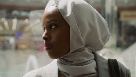 Eine-Afroamerikanische-Dame-Mit-Hijab-Fährt-Im-Aufzug-Im-Einkaufszentrum-Nach-Oben