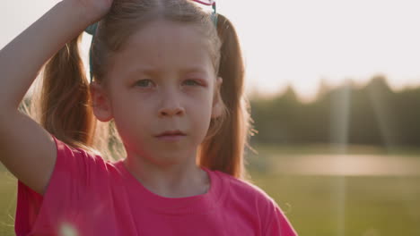 Little-girl-with-swollen-eyelid-takes-off-glasses-at-sunset