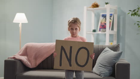 Offended-little-girl-shows-cardboard-paper-with-word-NO