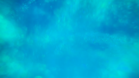 sky-blue-water-with-sparkles-runs-past-camera-closeup