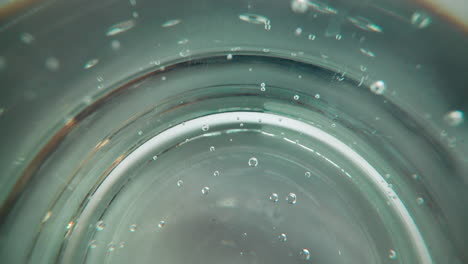 little-bubbles-float-up-inside-sparkling-water-in-glass