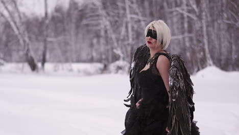 upset-actress-with-blindfold-plays-phoenix-in-winter-forest