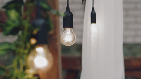 Edison-light-bulb-hangs-on-ceiling-in-spacious-restaurant