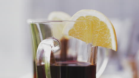 barman-puts-glass-with-delicious-red-mulled-wine-on-table