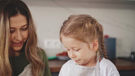 mother-and-little-girl-with-long-hair-are-in-kitchen