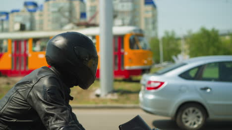Motorcyclist-rides-modern-vehicle-along-large-city-street