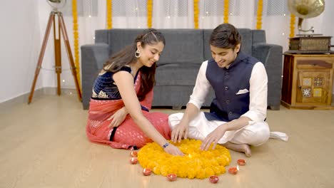 Indian-couple-decorating-home-for-Diwali