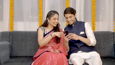 Indian-couple-watching-something-on-phone