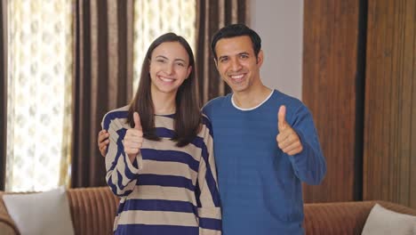 Happy-Indian-couple-showing-thumbs-up-to-the-camera