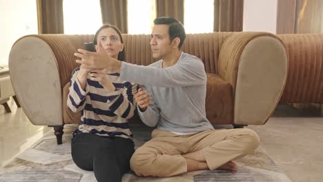 Indian-husband-and-wife-fighting-for-TV-remote