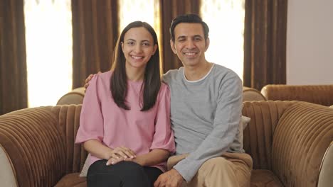 Happy-Indian-couple-smiling-to-the-camera