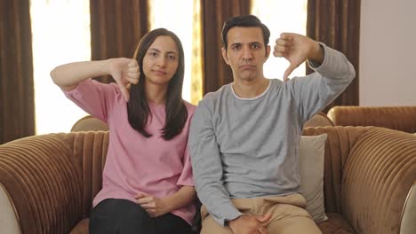 Upset-Indian-couple-showing-thumbs-down-to-the-camera
