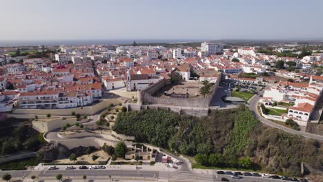 Aerial-view-orbiting-Castelo-de-Sines-historical-urban-seafront-regeneration-on-the-Portugal-coast-road