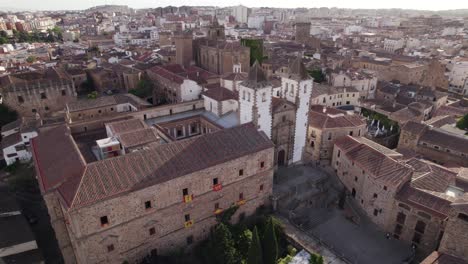 Famous-medieval-church-San-Francisco-Javier-in-Caceres,-Spain,-sunset-aerial