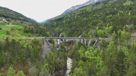 Antena-Acercándose-Al-Histórico-Puente-Ferroviario-De-Kylling-Pasando-Por-Encima-Del-Río-Verma-En-Rauma-Noruega