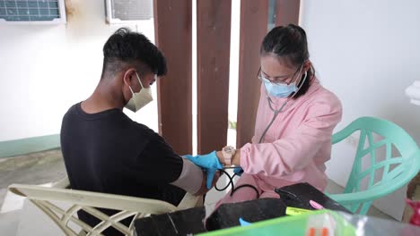 Asiatische-Krankenschwester-überwacht-Den-Blutdruck-Des-Patienten