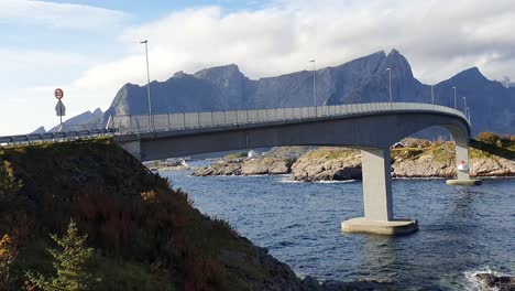 Brücke-über-Den-Fjord-In-Hamnoy-Mit-Einer-Beeindruckenden-Zerklüfteten-Berglandschaft-Im-Hintergrund