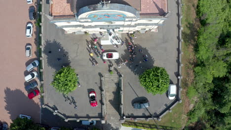 Oldtimer-for-bride-and-groom-in-front-of-church,-wedding-celebration,-aerial