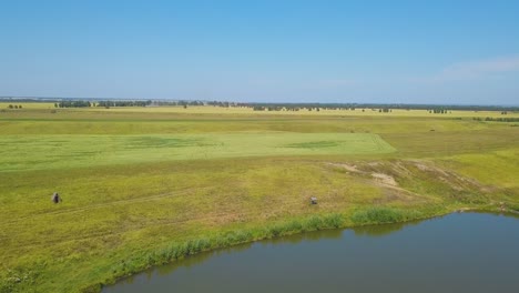 tranquil-lake-and-field-under-boundless-sky-aerial-panorama