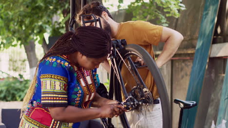 Young-persons-repairing-bicycle-outside