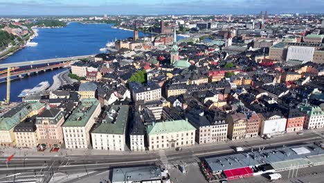 Drone-flyover-Gamla-Stan,-old-town-Stockholm-to-church-tower-surrounded-by-traditional-houses