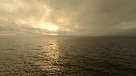 Sunrise-at-sea-on-an-overcast,-misty-morning---hyper-lapse
