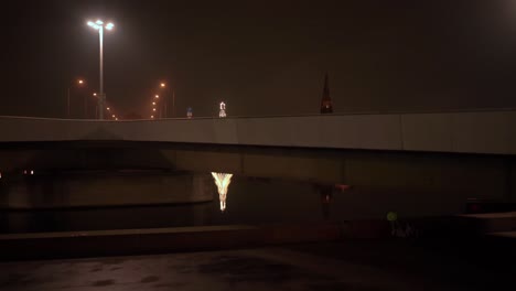 Wide-shot-under-Wilhelminabrug-bridge-revealing-Maastricht-illuminated-by-Christmas-lights