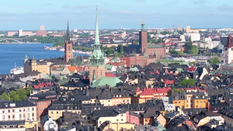 Towers-of-St-Gertrude,-City-Hall-and-Storkyrkan-surrounded-by-traditional-black-roof-homes-in-Stockholm-old-town