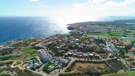 Drone-rises-and-tilts-down-to-reveal-exclusive-Curacao-resort-on-coastline