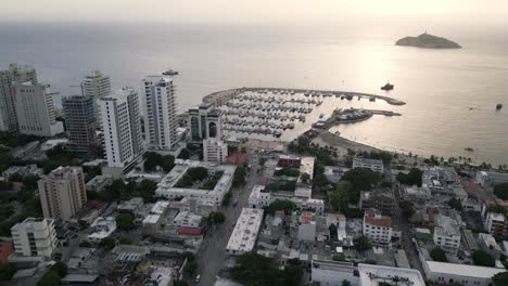 Aerial-Panoramic-Sunset-View-Above-Santa-Marta-Colombia-Marina-Yacht-Bay-Seaside-in-Caribbean-Beach,-Travel-and-Tourism