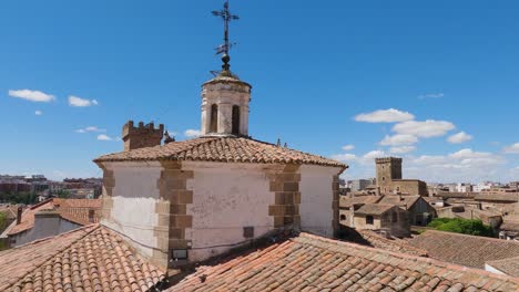 Static-wide-view-across-Caceres-rooftops,-church-spire-in-foreground