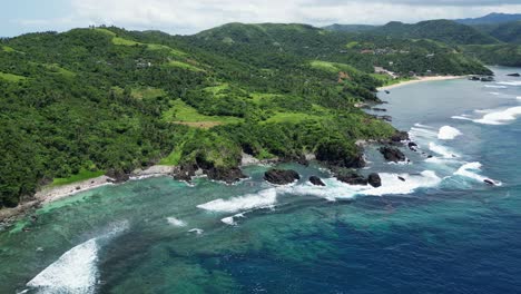 Picturesque-coastline-in-the-Philippines-on-a-sunny-summer-day,-aerial-orbit