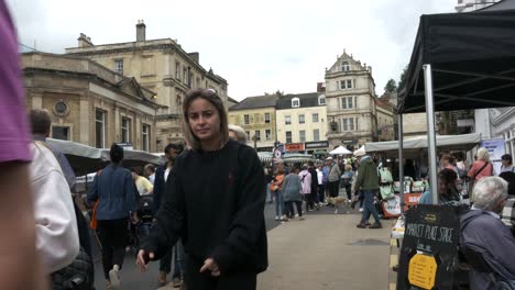People-stroll-down-the-high-street-during-market-day-in-a-town-in-England
