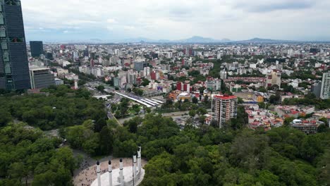 Flying-over-the-Chapultepec-forest,-with-a-view-the-interior-circuit-avenue,-Mexico-City,-Mexico