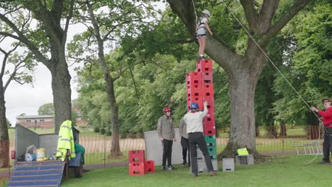 Child-climbing-high-on-crates