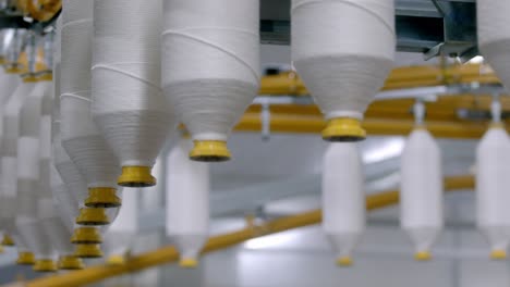 cotton-thread-yarns-spools,-textile-factory,-cinematic-shallow-focus-depth,-Organic-cotton-yarn-used-for-sustainable-eco-friendly-cotton-yarns-fabric-decentralised-production