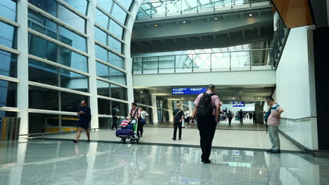 Static-shot-of-travelers-walking-to-their-flights-in-the-Hong-Kong-airport