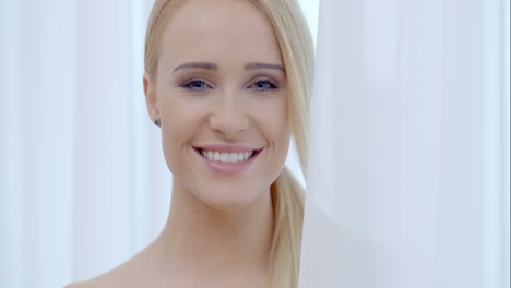 Pretty-Smiling-Woman-Behind-White-Curtain