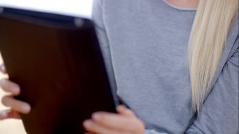 Blond-Woman-Busy-with-her-Tablet-Device