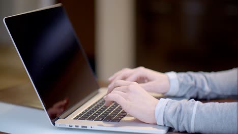 Woman-typing-on-a-laptop-computer