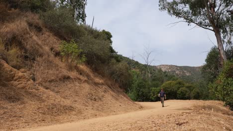 Man-hikes-on-trail-in-Griffith-Park-in-Los-Angeles