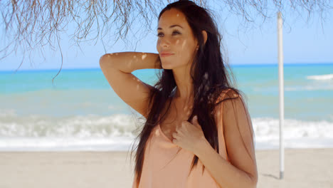 Thoughtful-Woman-Under-Beach-Umbrella-Looking-Afar