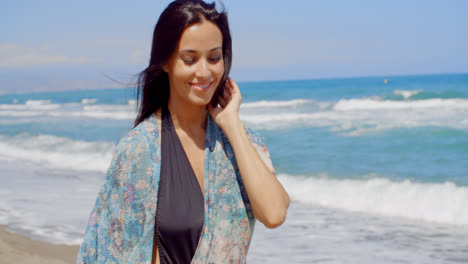 Thoughtful-Smiling-Woman-Walking-at-the-Beach