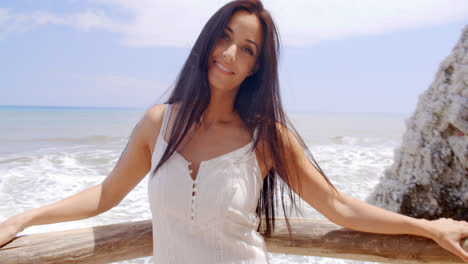 Pretty-Lady-Leaning-her-Back-Against-Beach-Railing