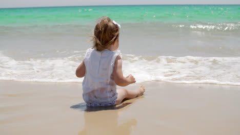 Cute-young-girl-paddling-in-the-surf