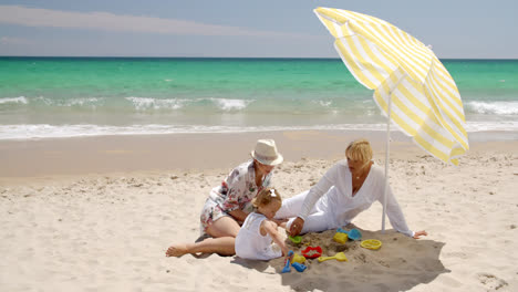 Oma-Und-Kleines-Mädchen-Spielen-Im-Strandsand