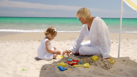 Cute-Girl-and-Grandmother-Playing-on-the-Beach