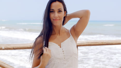 Gorgeous-Lady-in-White-Standing-at-Beach-Pathway